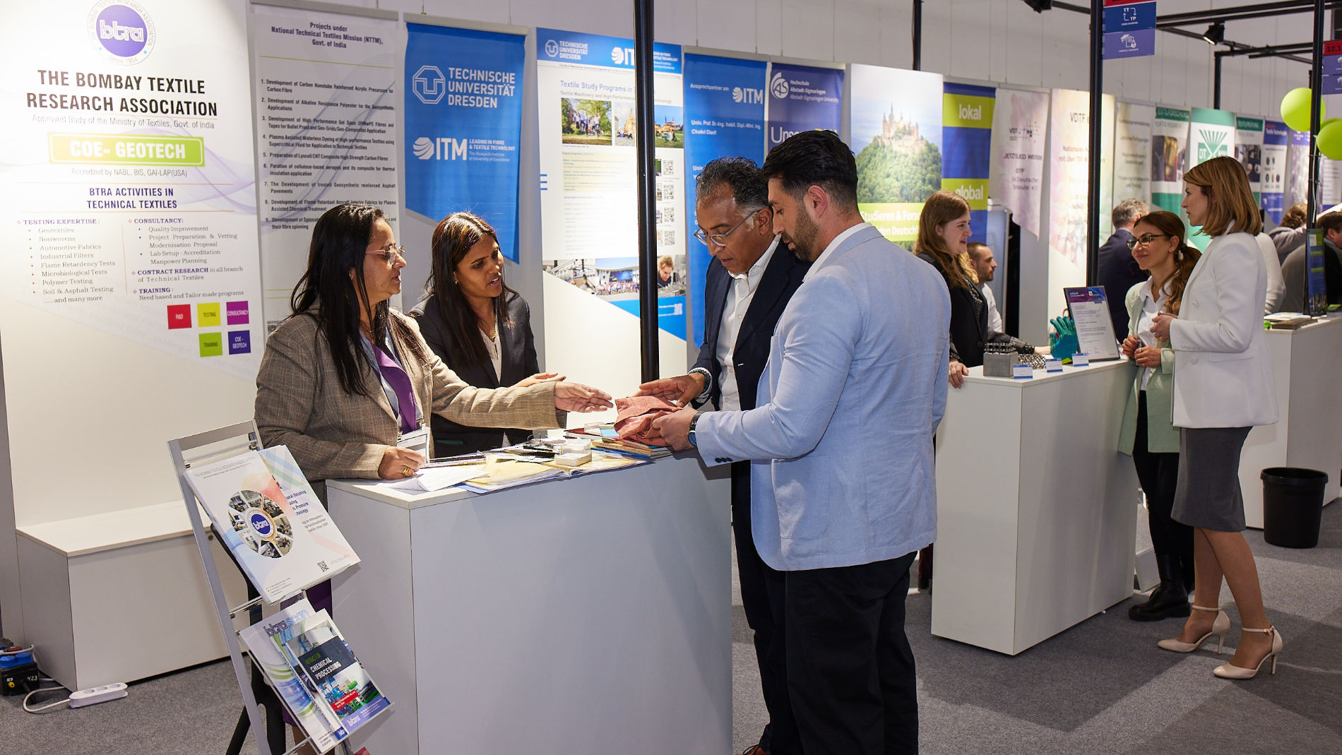 Visitors chatting at the exhibition stand
